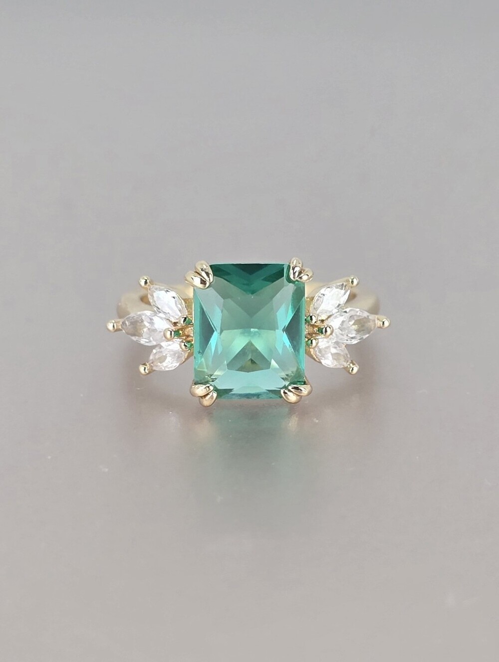 Gold Ring with Emerald Green Square Center and Clear Accent Stones